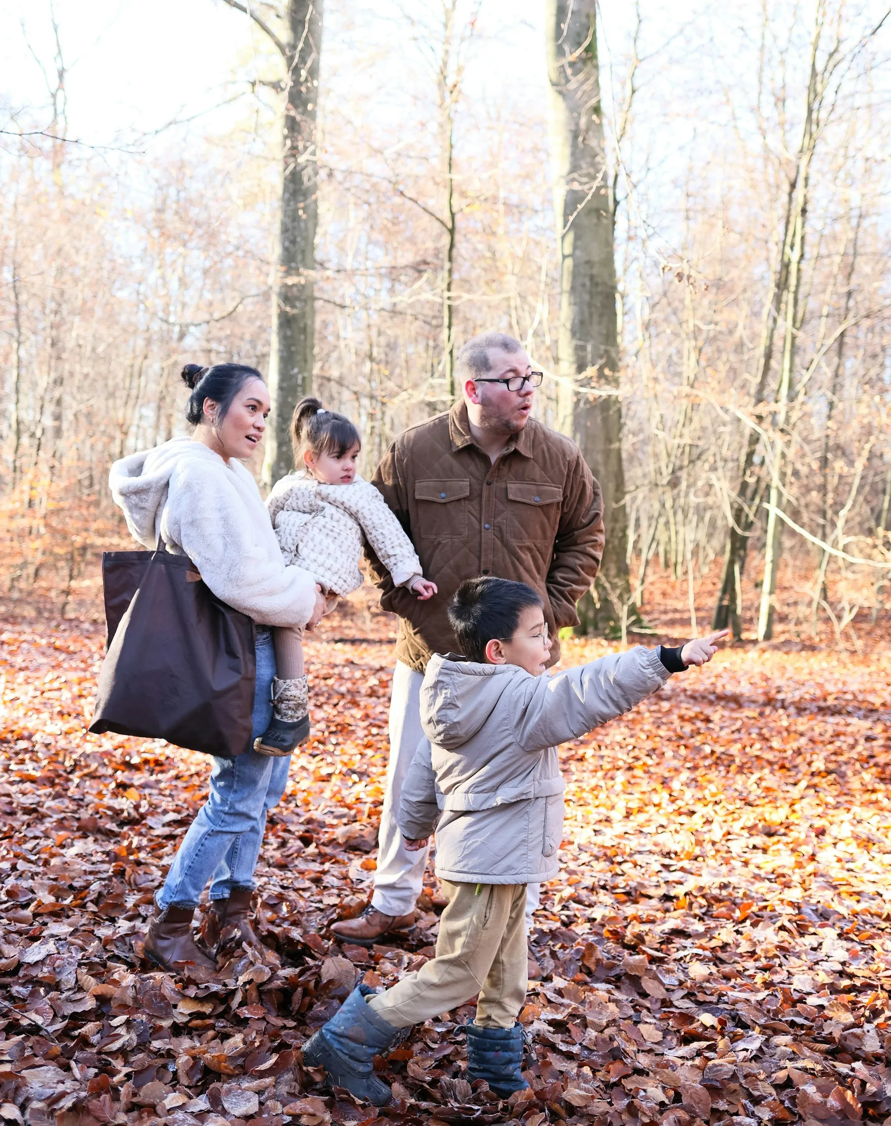 A family walking together through an autumn forest