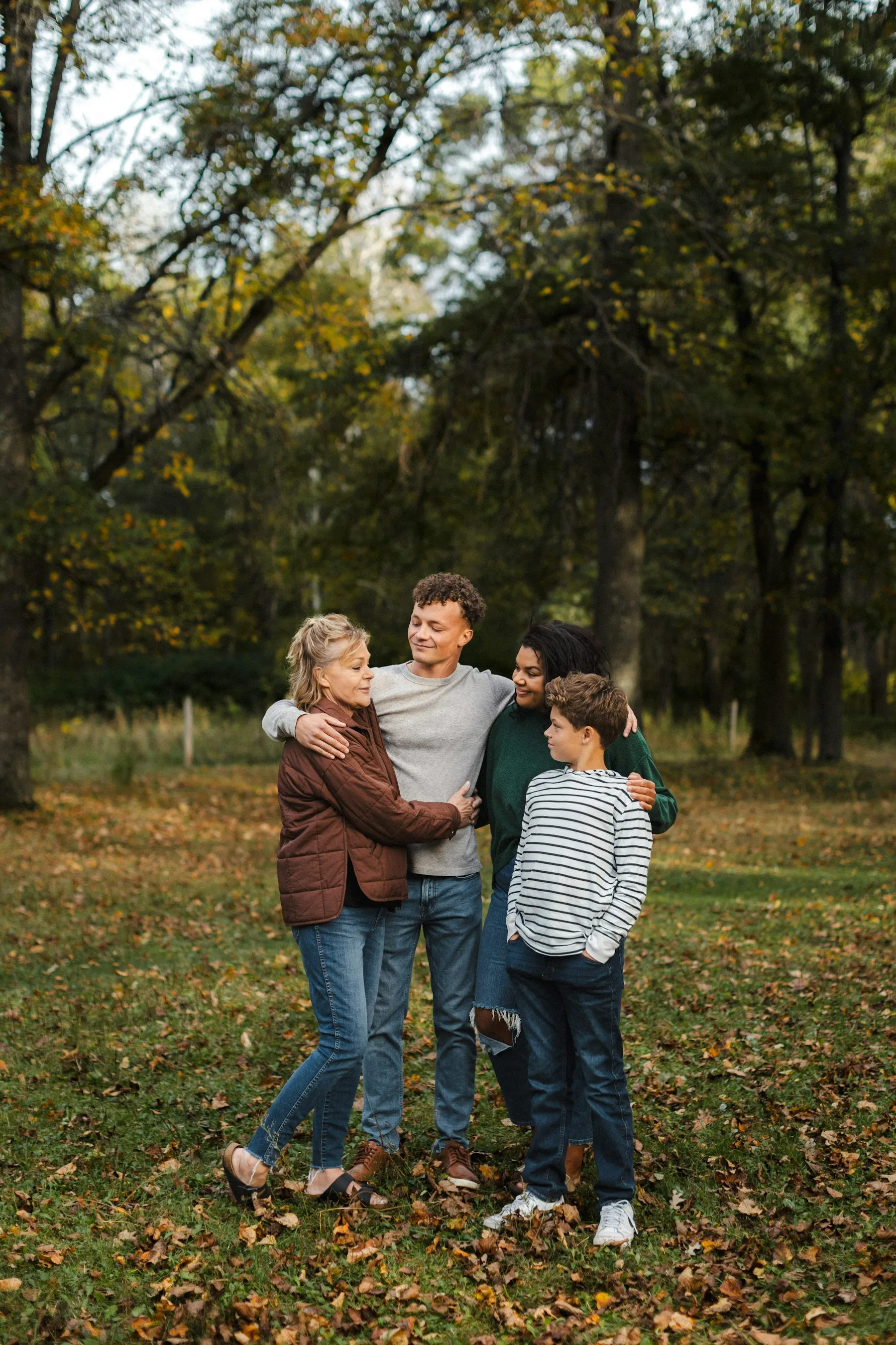 A mother and daughter share a warm embrace outdoors